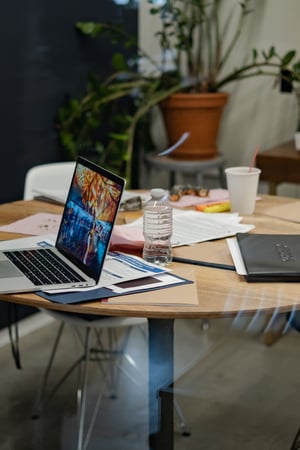 A laptop and notebook in an office space